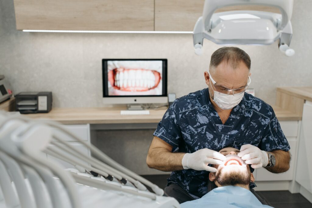 A dentist is working on a patient.