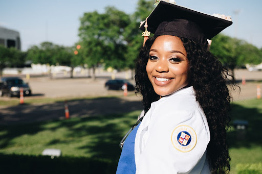 A graduate smiling for the camera.